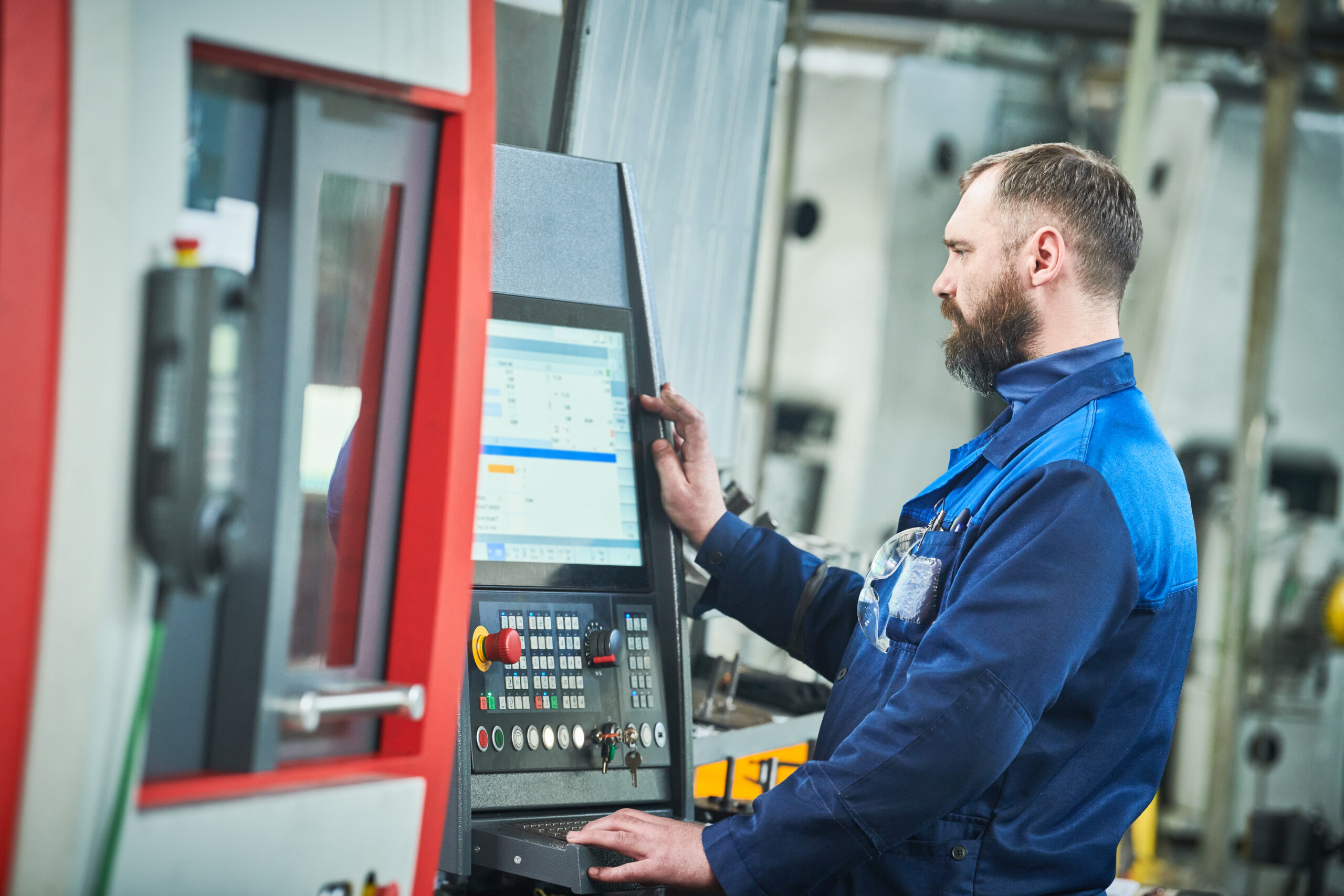 CNC engineer using precision machinery protect with CNC machine insurance for new and used equipment